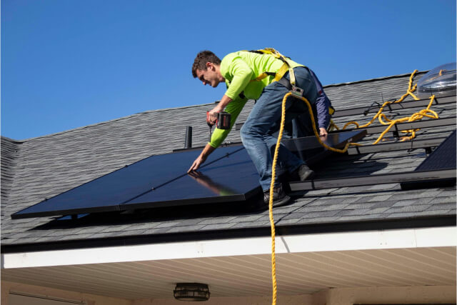 man installing a solar panel